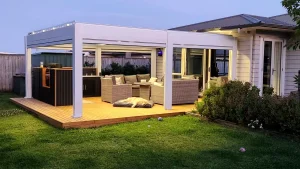 White Louvered Pergola Outdoor Lounge Evening