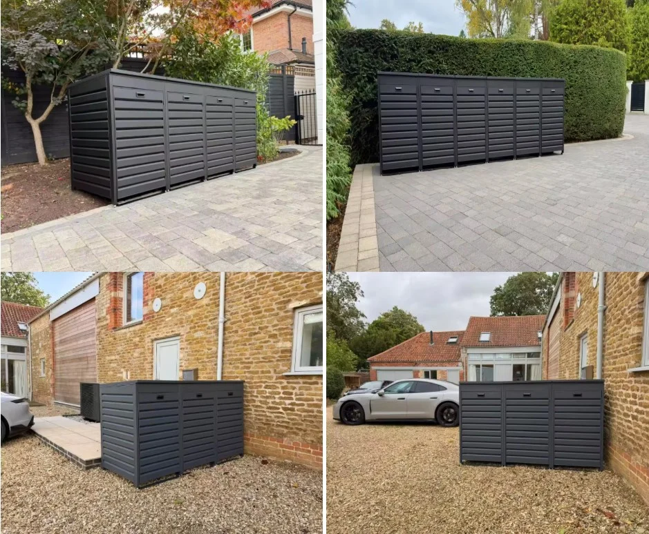 Outdoor modular metal wheelie bin storage shed enclosure installed on residential driveway and estate courtyard