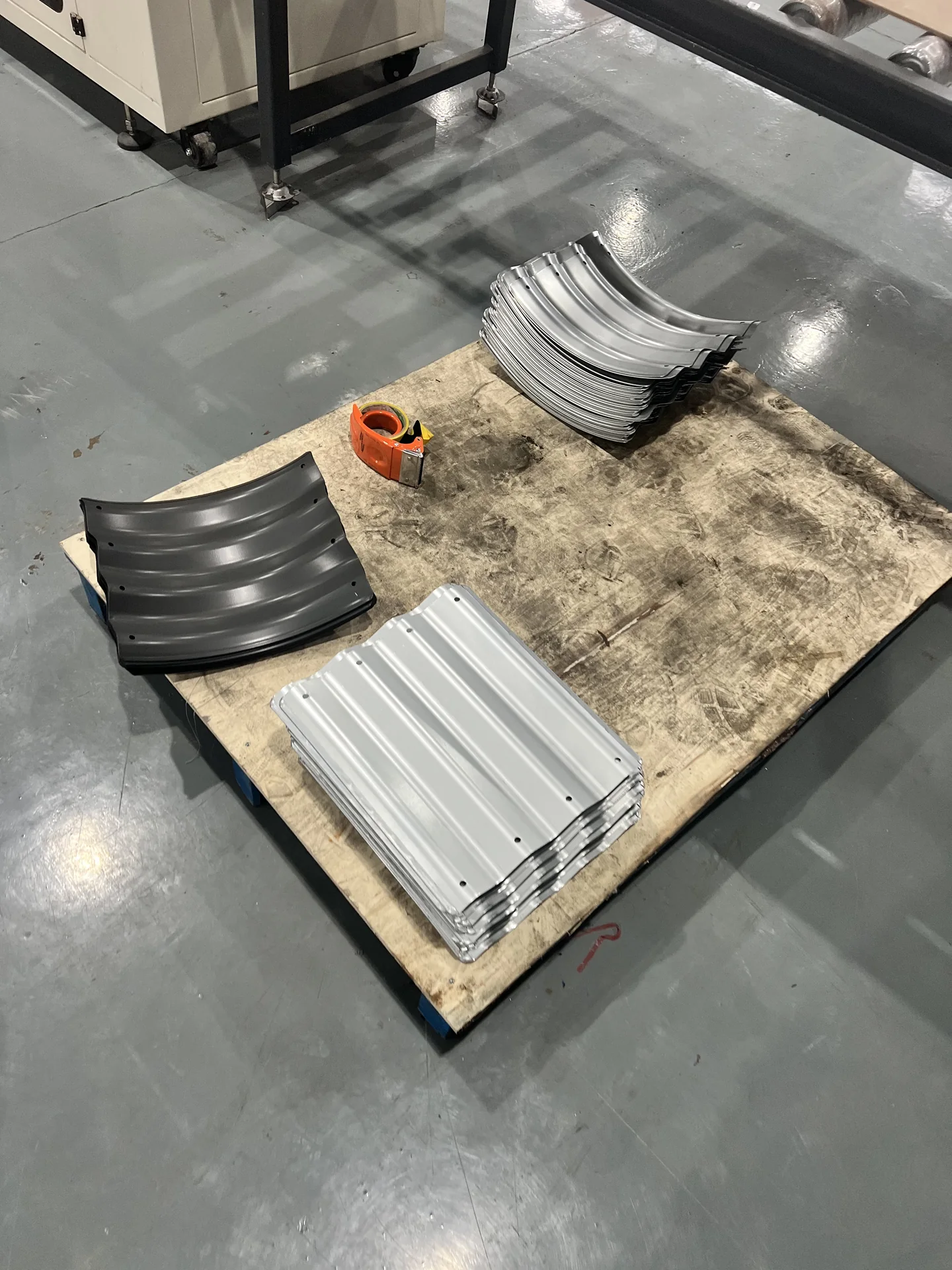 Corrugated metal raised bed panels organized during factory production