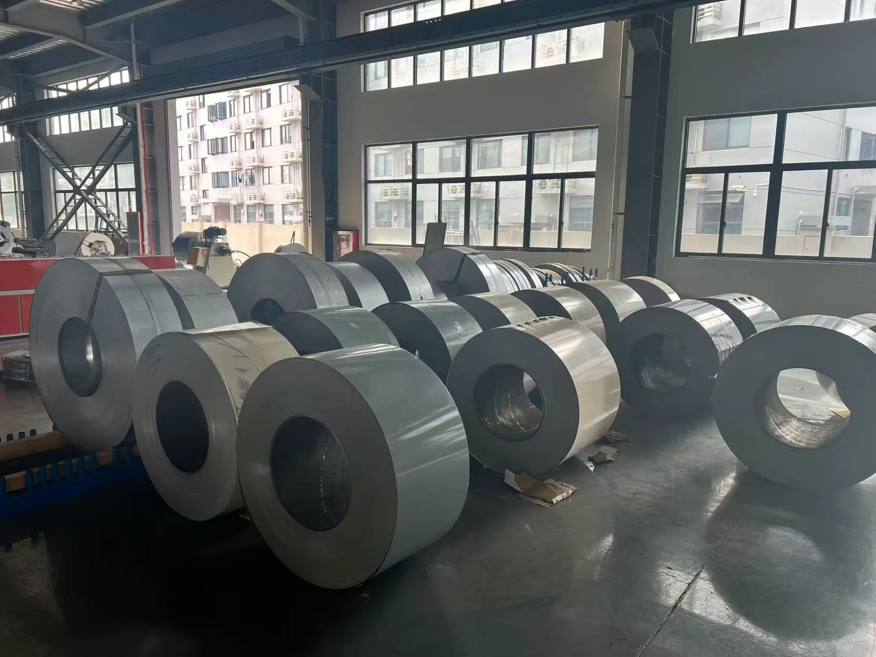 Pre-painted steel coils being cut and processed for custom metal raised garden beds